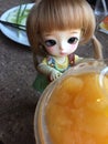 An adorable BJD ball joint doll) and orange juice